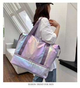 Detail of holographic purple travel bag showing water-resistant bottom compartment