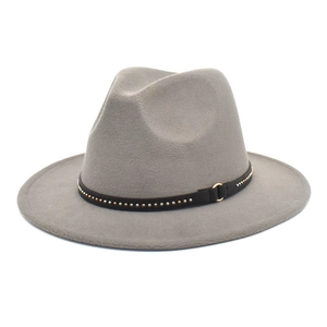 Detail of grey felt fedora hat featuring a black studded band and gold metal buckle