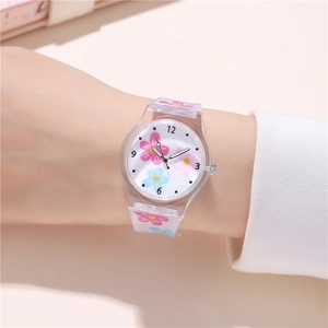 Close-up of kids quartz watch with floral patterns on a clear strap worn on the wrist