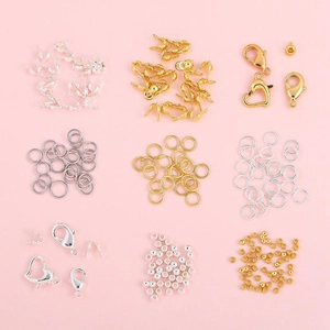 14k gold-filled lobster clasps and jump rings set for DIY jewelry making on pink background