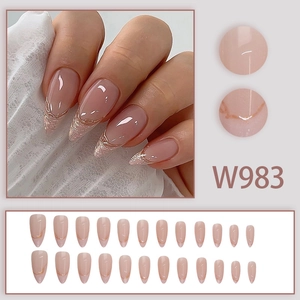 Long almond press-on nails with nude glitter base and champagne gold French tips