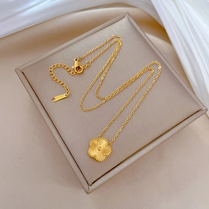 Gold plated stainless steel four leaf clover pendant necklace on jewelry box