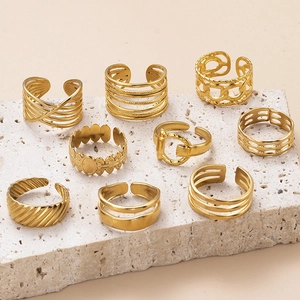 9-piece gold stainless steel geometric ring set with chain and twist designs on stone