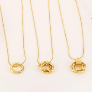 Detailed view of three minimalist gold-plated necklaces with intertwined triple ring pendants