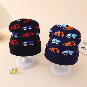 Detail of winter knitted baby hats with colorful cartoon excavator jacquard patterns