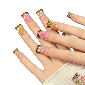 Pink floral tiger print press-on nails with metal stars and crystal cross charms
