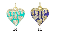 Detailed view of 18K gold plated heart charms with enamel drip and zircon inlay