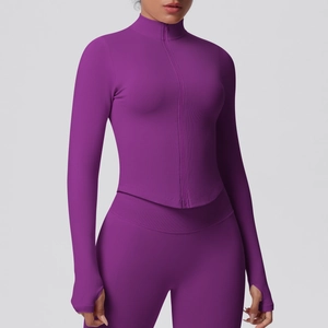 Detailed view of the zip-up collar and ribbed texture on this magenta yoga jacket