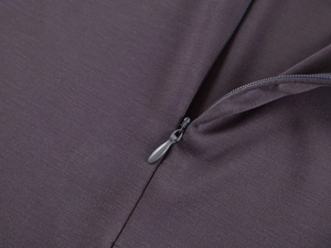 Close-up of the smooth hidden zipper and dark knit texture on a dry-fit yoga top