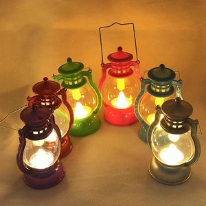 Macro detail of six colorful vintage-style LED lanterns glowing on textured fabric