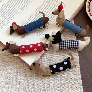 Detailed view of handmade dachshund hair clips with various polka dot and corduroy patterns