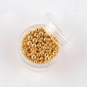 Macro di perline metalliche dorate in scatola per nail art e decorazioni artigianali