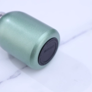 Bottom view of mini stainless steel water bottle with green matte finish and silicone pad