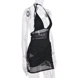 Detail of sheer mesh patchwork dress with plunging halter neckline and side slit