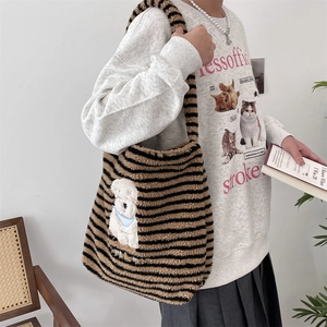 Detail of a large capacity striped plush tote bag featuring a cute cartoon dog patch