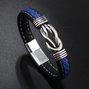 Close-up of black and blue braided leather bracelet with silver infinity magnetic clasp