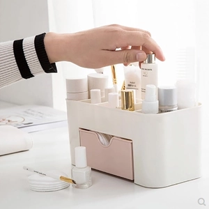 White and pink plastic makeup organizer with drawers for cosmetics and jewelry