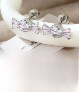Macro shot of pink candy-shaped cartilage stud with rhinestones and disk backing