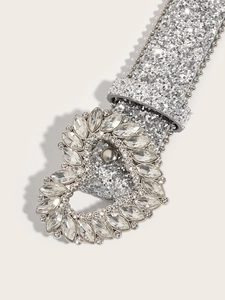 Detail of silver sparkling belt with large heart buckle set in marquise and round rhinestones