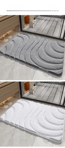 Detail of 3D wave texture on absorbent grey and white non-slip bathroom mats