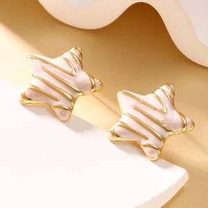 Detailed macro view of vintage star stud earrings with pink marble enamel and gold trim