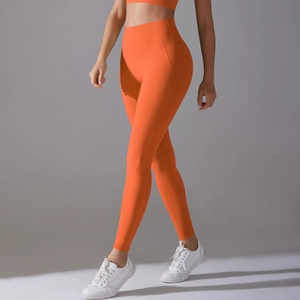Close-up of orange high-waist yoga pants featuring ergonomic seams and quick-dry fabric