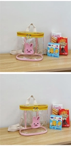 Close-up of a clear PVC backpack with pink bunny patch and yellow zipper detail