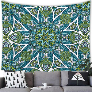 Detailed blue-green mandala tapestry hanging over a sofa in a modern boho living room decor