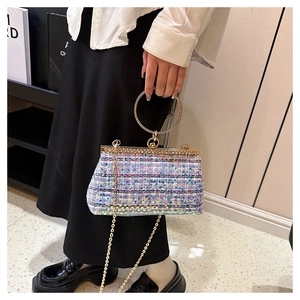 Detail of tweed evening bag featuring sequins, diamond ring handle and gold chain strap