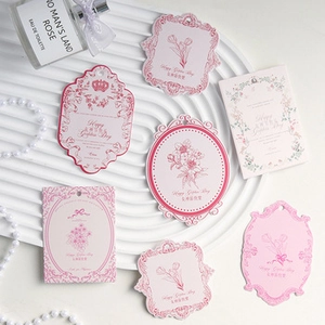 Pink vintage floral tags with Happy Golden Day greeting on a luxury white display tray