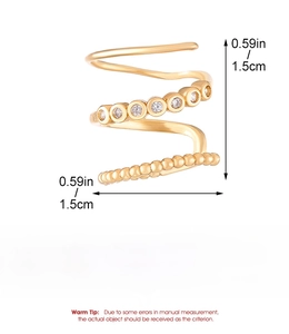 Detailed view of gold multi-layer spiral cuff with zircon stones and bead texture