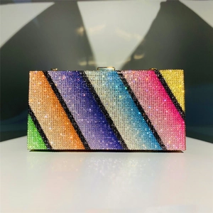 Macro shot of rectangular clutch with rainbow crystal rhinestones and golden metal clasp