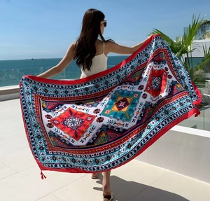 Close-up of ethnic geometric print beach shawl with fringe edges under the sunlight