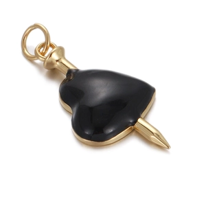 Golden nail piercing a black heart pendant with glossy enamel finish for jewelry DIY