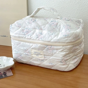 Detail der weichen Baumwoll-Kosmetiktasche mit floralem Muster und Reißverschluss