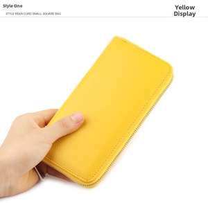 Detailed view of long yellow lychee pattern leather wallet with silver metal zipper closure