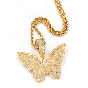 Macro shot of gold butterfly pendant necklace with full pavé diamonds and twist chain