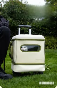 Macro shot of a detachable pet carrier with wheels and transparent window on green grass
