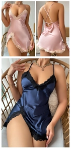Detail view of lace trim deep V-neckline and crisscross back straps on silk satin nightgown