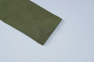 Detailed close-up of olive green dress hem showing premium double-needle stitching
