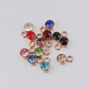 Macro shot of 13 colorful birthstone charms with rose gold plating for DIY jewelry