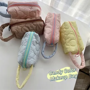 Quilted floral cosmetic bags in pastel candy colors with cloud stitching and soft texture