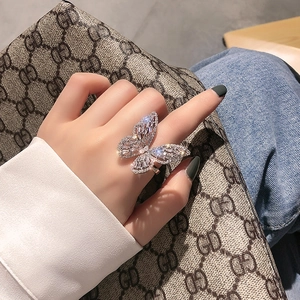 Sparkling silver butterfly open ring with zircon crystals worn by a model on index finger