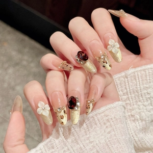 Detail of luxury almond fake nails with leopard print and 3D floral gemstone