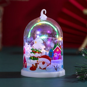 Detail of a bell-shaped Christmas LED night light with snow scene and colorful lights