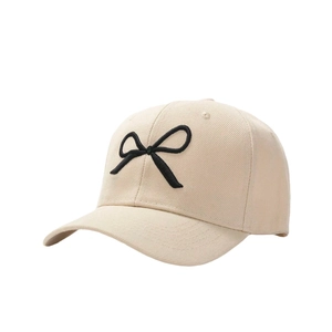 Beige cotton baseball cap with a 3D black embroidered bow and sun protection design