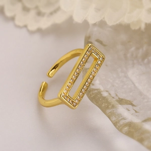 Macro detail of gold plated zircon ring featuring rectangular hollow pave diamond design
