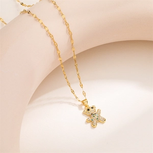 Detailed close-up of a gold necklace with a colorful zircon micro-pave bear pendant