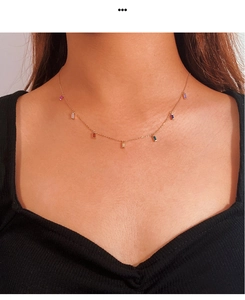 Close-up of 925 silver gold necklace with colorful zircon pendants on model neck