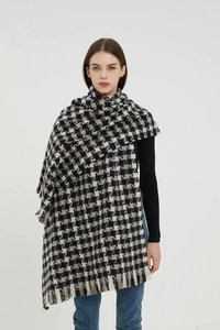 Detail of soft black and white houndstooth scarf showing thick texture and fringe trim